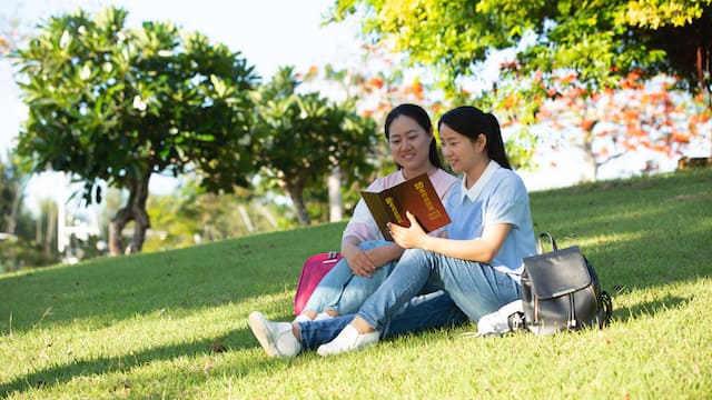 Christians sitting in the park reading God's words