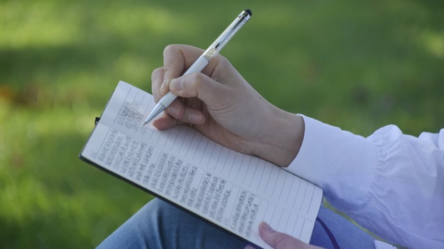 A persecuted christian writting her story in notebook