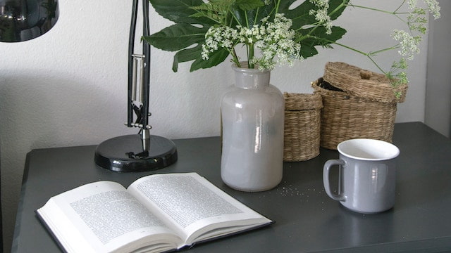 A book and a cup on the table, reading book